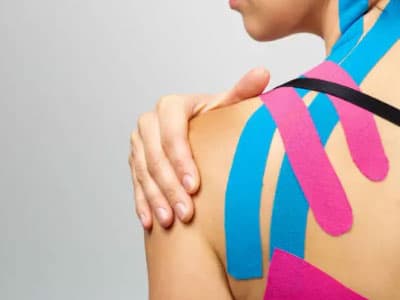 Patient performing a supported movement exercise with kinesio taping