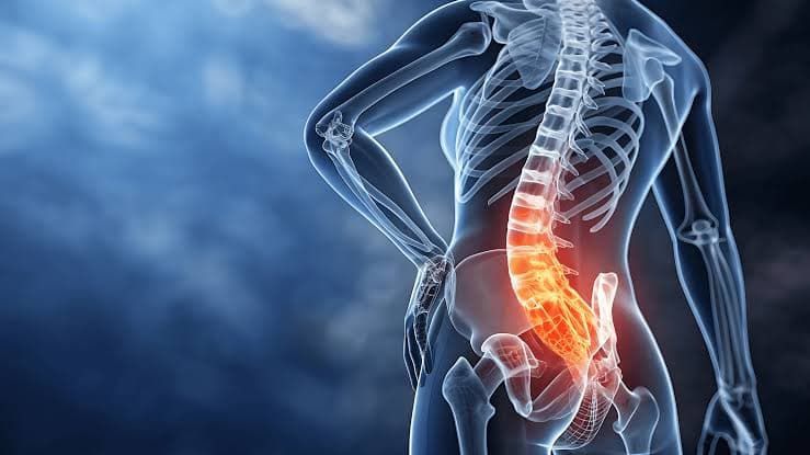 Physiotherapist assessing a patient's lower back and sciatic nerve symptoms at AlignAsya